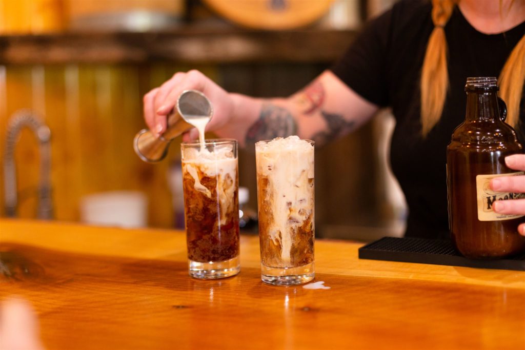 Rebekah Neeley pours adult root beer floats for Kathrine Nero at Neeley Family Distillery. Tasha Pinelo Photography